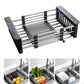 a stainless steel sink rack holding plates, fruits and vegetables